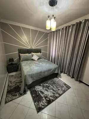 a bedroom with a bed and some curtains at Tranquility In the Center of Fez in Fès