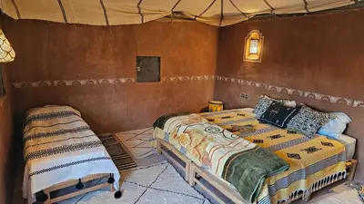 a bedroom with two beds in a room at Nejma luxury camp erg chegaga in El Gouera