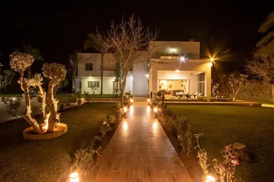 a house with lights in the yard at night at Villa Meriem, Fès in Oulad Tayeb