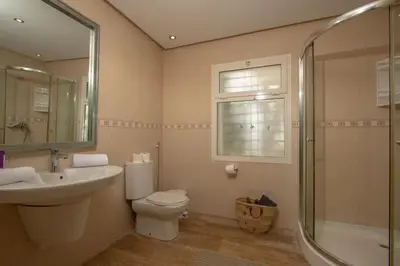 a bathroom with a toilet and a sink and a shower at Villa Meriem, Fès in Oulad Tayeb