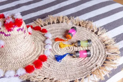 a straw hat with two bottles on top of it at Alibaba Merzouga Camp in Merzouga