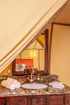 a bathroom counter with a sink and a mirror at Alibaba Merzouga Camp in Merzouga