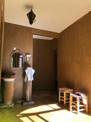 a bathroom with a sink and a mirror on the wall at Guest House Tigminou in Setti Fatma