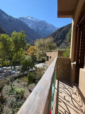 a balcony of a house with a view of a mountain at Guest House Tigminou in Setti Fatma
