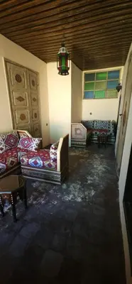 a living room with couches and a chandelier at Dawya terrace in Fès