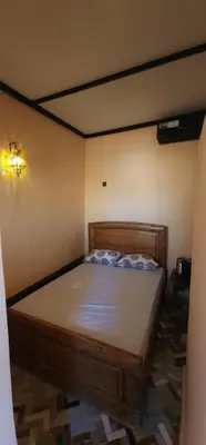 a bedroom with a wooden bed in a room at Dawya terrace in Fès