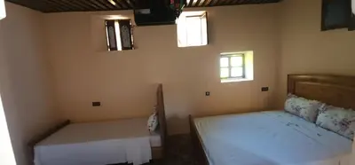 two beds in a room with two windows at Dawya terrace in Fès