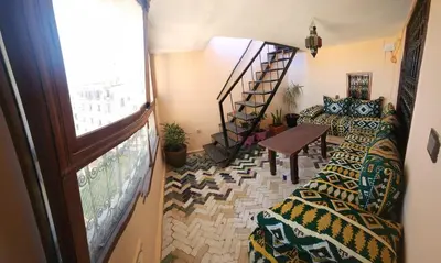 a living room with a staircase and a window at Dawya terrace in Fès
