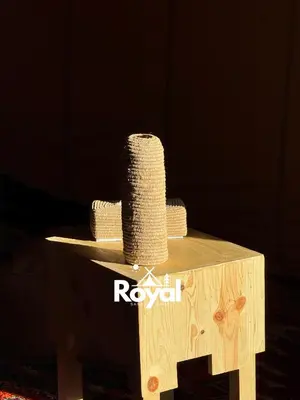 a wooden table with a roll of yarn on it at Royal Sands Camp in Merzouga
