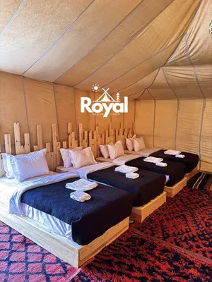 two beds in a room in a tent at Royal Sands Camp in Merzouga