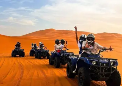 a group of people riding on atvs in the desert at Sahara Nights Luxury Camp in Merzouga