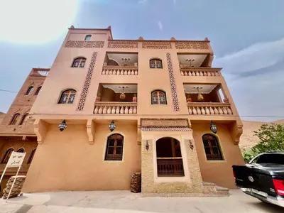 a large building with a balcony on top of it at Grand Canyon Lodge Dades in Aït Idaïr