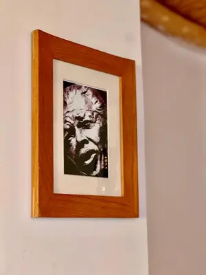 a framed picture of a man on a wall at Grand Canyon Lodge Dades in Aït Idaïr