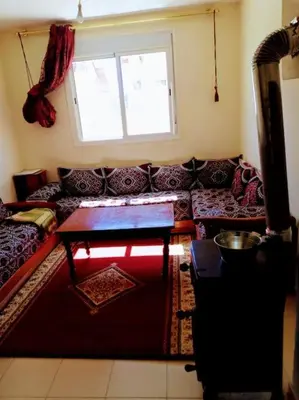 a living room with a couch and a window at Cozzy F2 appartement Ifrane in Ifrane