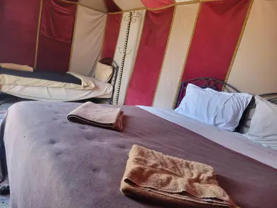 a close up of a bed in a room at Bright Star Desert Camp in Merzouga