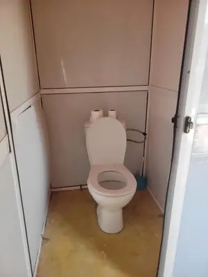 a small bathroom with a toilet in a trailer at Bright Star Desert Camp in Merzouga