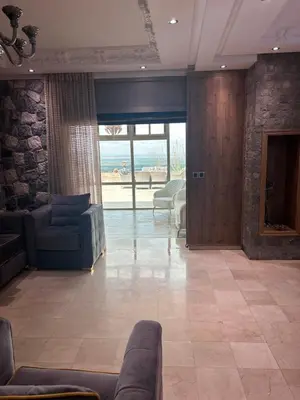 a living room with a couch and a stone wall at Villa SKYVIEW in Beni Mellal