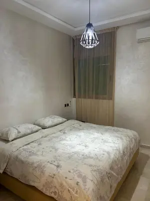 a bedroom with a bed and a chandelier at Villa SKYVIEW in Beni Mellal