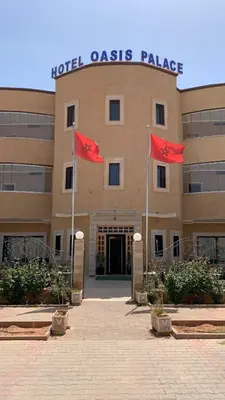 two red flags in front of a hotel costs palace at Hotel Oasis Palace in Er Rachidia