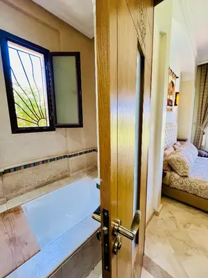 a bathroom with a bath tub and a window at Entire villa with private pool in Marrakech in Marrakech