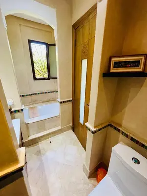 a bathroom with a toilet and a window at Entire villa with private pool in Marrakech in Marrakech