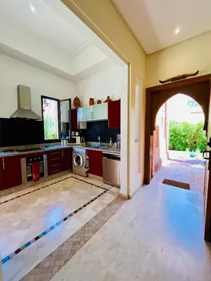 a kitchen with an open door to a kitchen with a washer at Entire villa with private pool in Marrakech in Marrakech