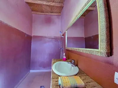 a bathroom with a sink and a mirror at Maison d'hôtes imouzzar asfalou in Aït Ben Haddou