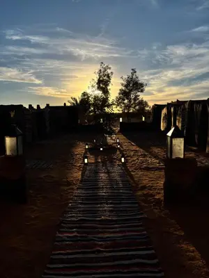 a row of lights in the middle of a dirt road at Camp Desert Sky in Merzouga