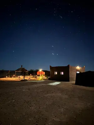 a parking lot at night with the stars in the sky at Camp Desert Sky in Merzouga