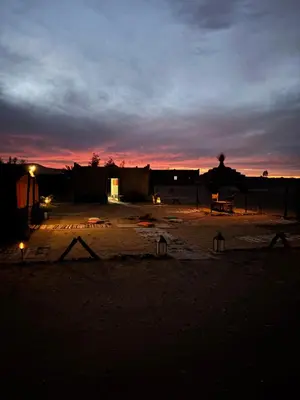 a night view of a desert with a sunset at Camp Desert Sky in Merzouga