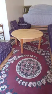 a coffee table in a living room with a rug at chez zoubida in Meknès