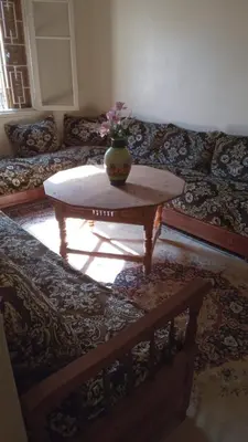 a living room with a couch and a coffee table at chez zoubida in Meknès