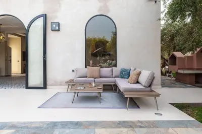 a living room with a couch and a coffee table at Villa les Oliviers avec piscine privée & jardin - Atlas view in Marrakech