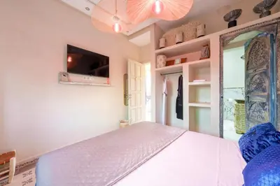 a bedroom with a bed and a mirror at Villa les Oliviers avec piscine privée & jardin - Atlas view in Marrakech