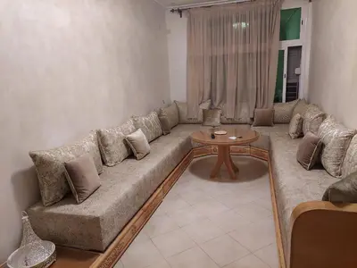 a living room with a couch and a table at Hi Home in Meknès