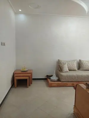 a living room with a couch and a table at Hi Home in Meknès
