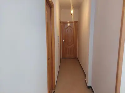 a hallway with a wooden door in a room at Hi Home in Meknès