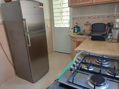 a kitchen with a stainless steel refrigerator and a stove at Hi Home in Meknès