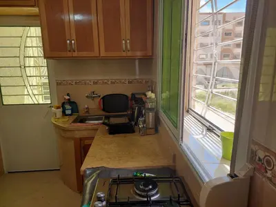 a small kitchen with a sink and a window at Hi Home in Meknès