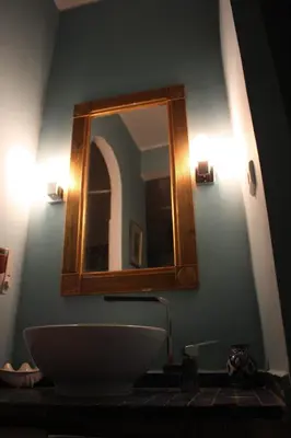 a bathroom with a sink and a mirror on the wall at Ryad Meknassia in Meknès