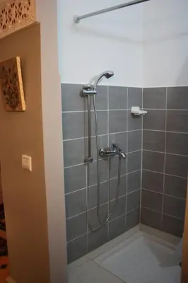 a shower with a shower head in a bathroom at Ryad Meknassia in Meknès