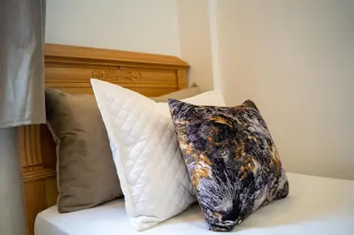 two pillows are sitting on a bed at La Terrassa appartement climatisé in Azrou