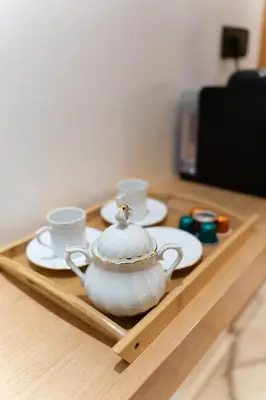 a tea pot and cups on a wooden tray at La Terrassa appartement climatisé in Azrou