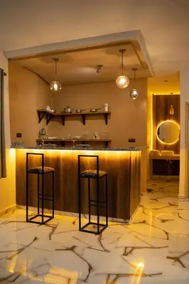 a lobby with a bar with two stools at La Terrassa appartement climatisé in Azrou