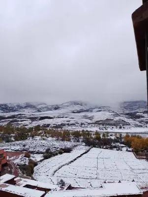 an aerial view of a snow covered field with trees at AYA Farm,Ferme d'hotes Aguelmous in Khenifra