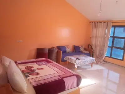 a living room with a couch and a table at AYA Farm,Ferme d'hotes Aguelmous in Khenifra