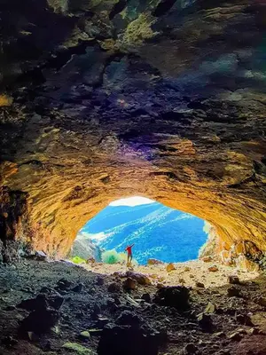 a painting of a person standing inside of a cave at AYA Farm,Ferme d'hotes Aguelmous in Khenifra