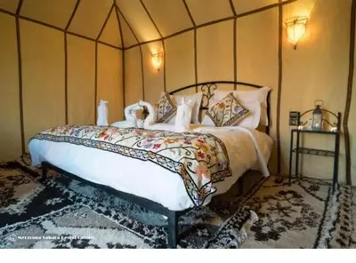 a bedroom with a large bed in a room at Guest House Nomad Life in Merzouga