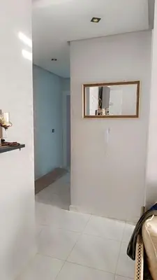 a room with white walls and a mirror on the wall at Appartement Basatine in Fès