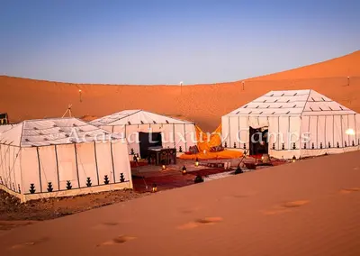 an aerial view of three tents in a desert at Merzouga Desert Camps in Merzouga